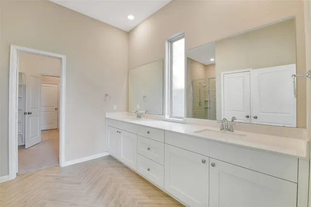 a bathroom with double sink and a mirror