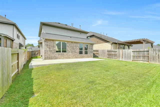 a view of a house with a yard and sitting area