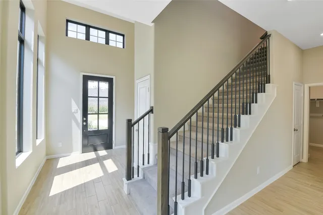 a view of an entryway with wooden floor and door