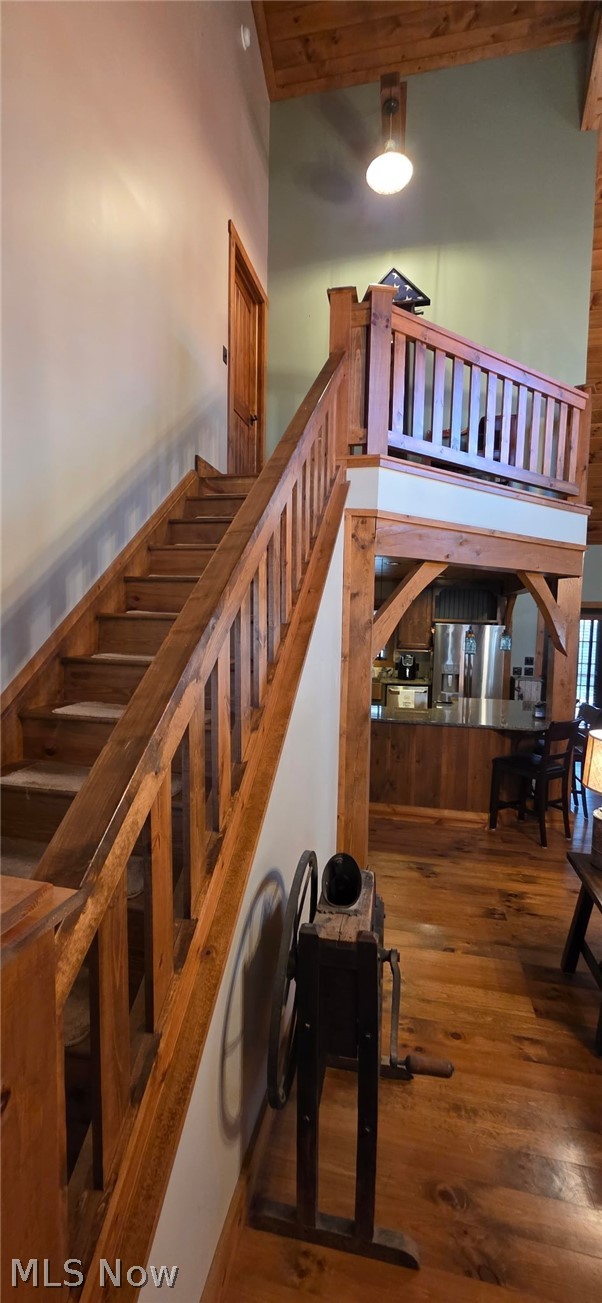 3989 Court Road Wakeman, OH 44889 - Photo 2 of 36 Stairs with hardwood / wood-style floors and a high wooden ceiling