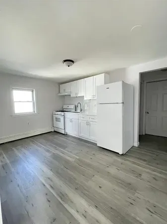 a big room with wooden floors and white walls