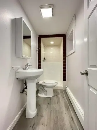 a bathroom with a sink toilet and shower