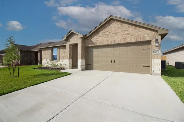 a front view of house with yard and green space