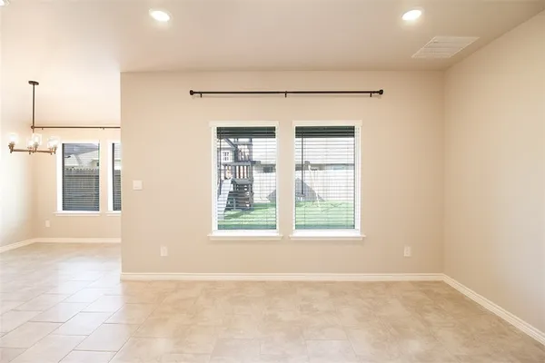 an empty room with windows and entrance