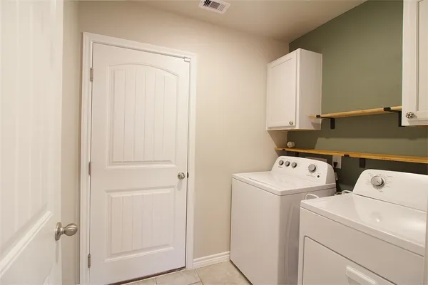 a view of storage and utility room with washer and dryer