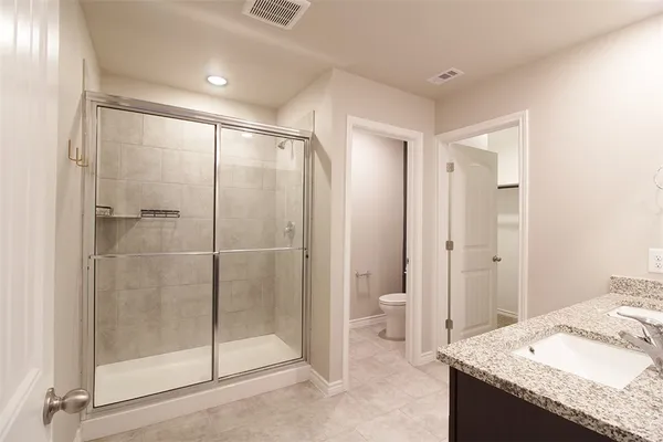 a bathroom with a granite countertop sink mirror and shower