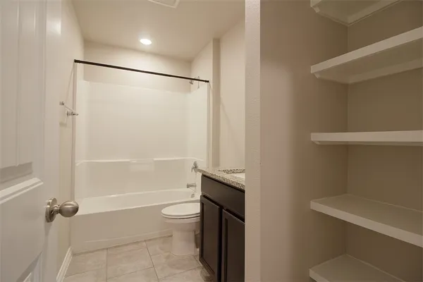 a bathroom with a toilet a sink and shower