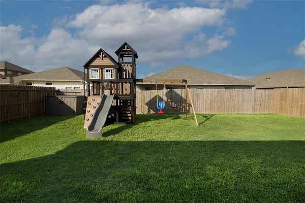a childrens park with lots of swings and slides
