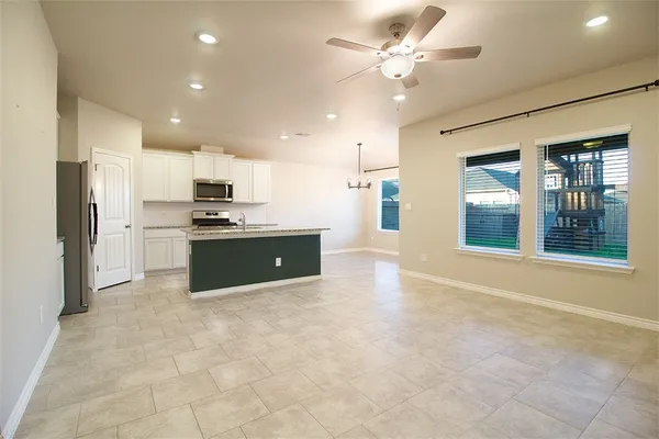 a large kitchen with cabinets and stainless steel appliances