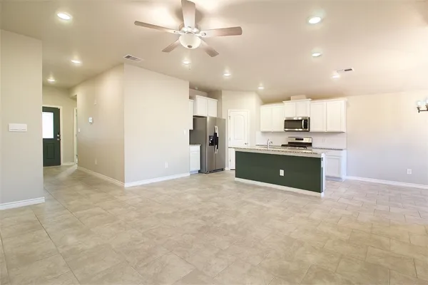 a kitchen with stainless steel appliances a refrigerator sink and cabinets