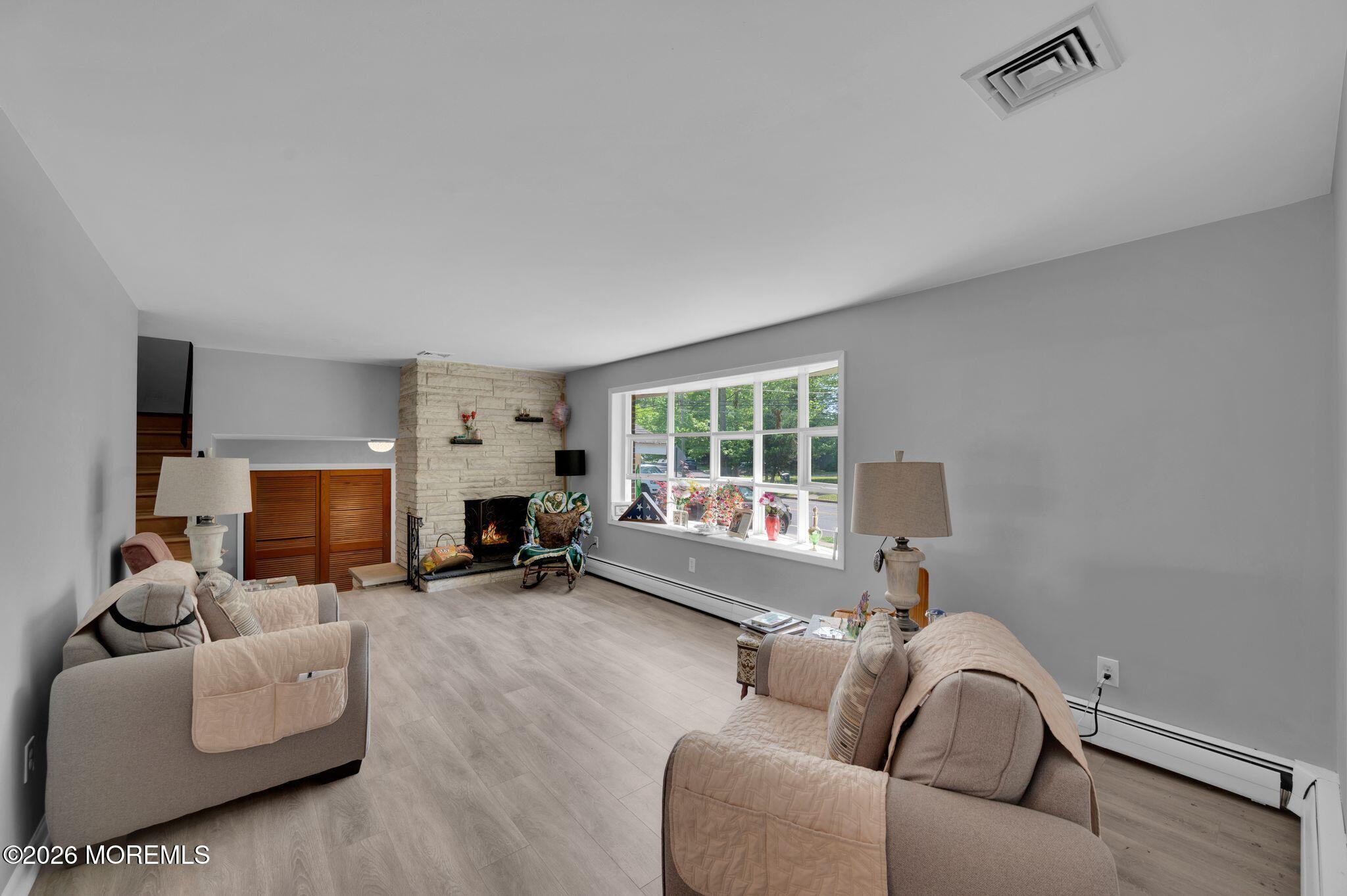 2604 Logan Road Asbury Park, NJ 07712 - Photo 8 of 39 a living room with furniture and a fireplace