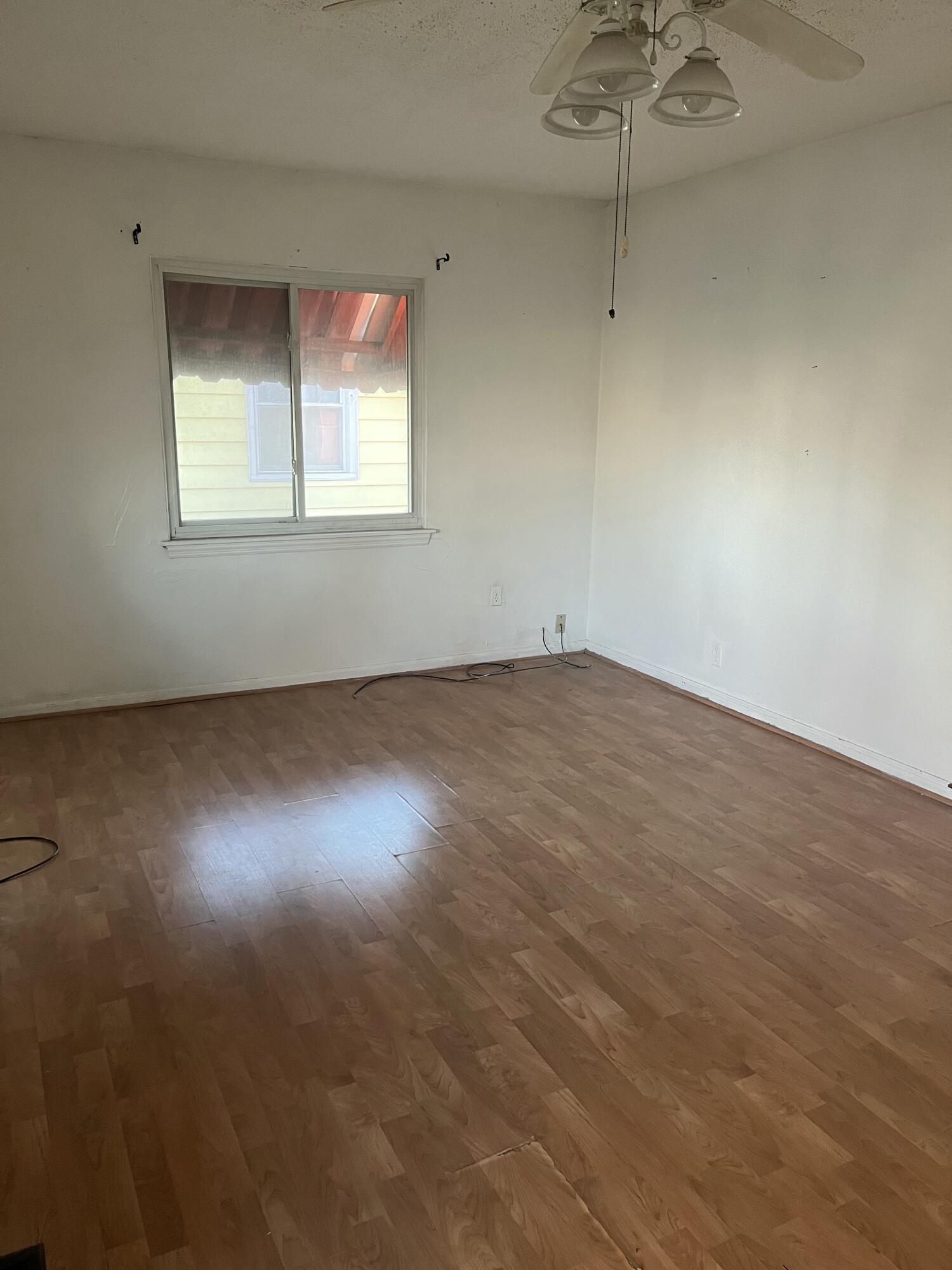 336 West Wilson Street Gary, IN 46404 - Photo 14 of 15 a view of an empty room with a window and wooden floor