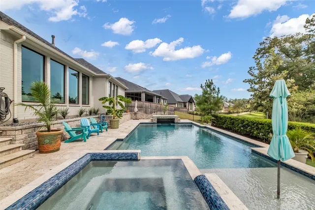 a view of a swimming pool with outdoor seating