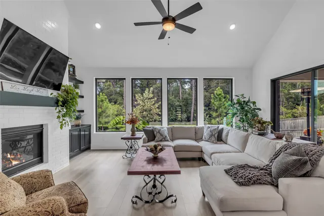 a living room with furniture fireplace and flat screen tv