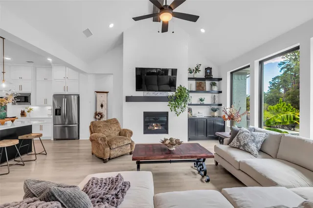 a living room with furniture fireplace and window