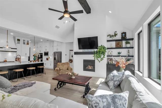 a living room with furniture a fireplace and a flat screen tv