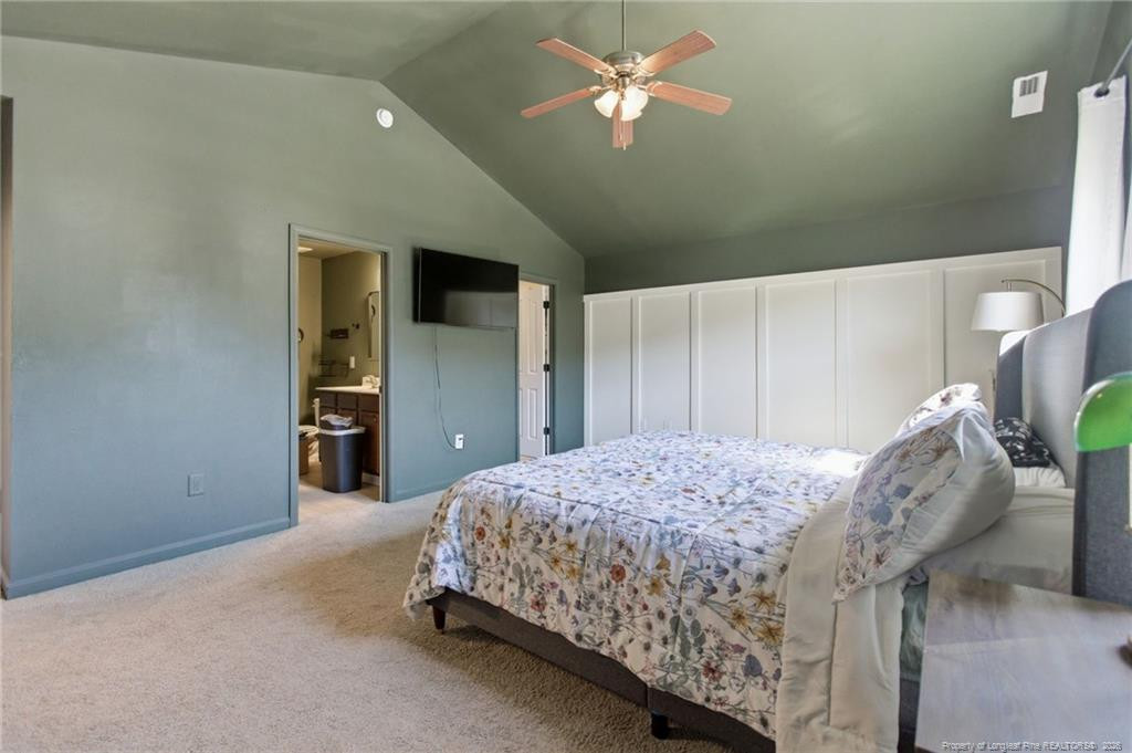 334 Crane Way Bunnlevel, NC 28323 - Photo 29 of 45 a bedroom with a bed and a chandelier