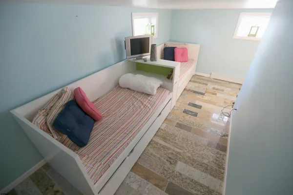 a bedroom with a bed and a television