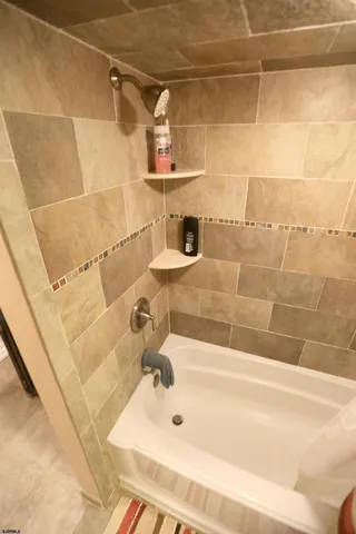 a bathroom with a bathtub and a shower