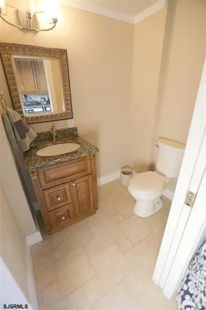 a bathroom with a stove a sink and a mirror