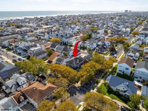 an aerial view of residential houses with city view