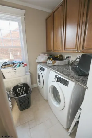 a view of washer and dryer with kitchen in the background