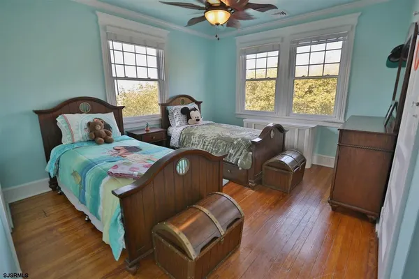 a bedroom with two beds and a window
