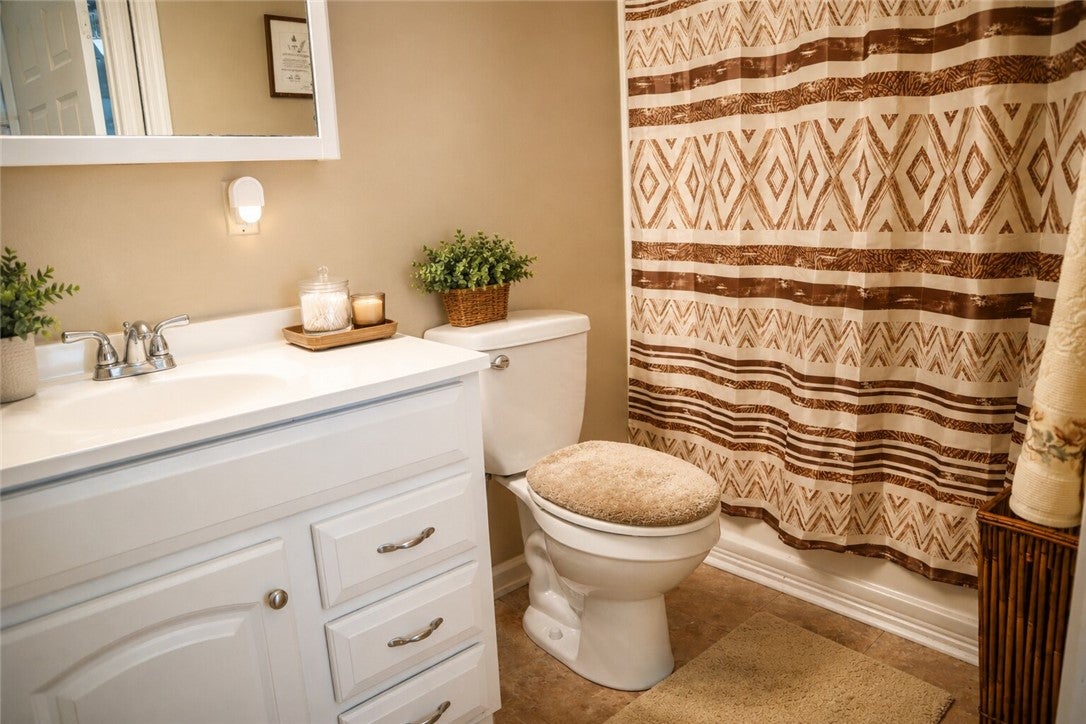 1075 Lowe Road Notasulga, AL 36866 - Photo 14 of 16 This clean and inviting bathroom features a single vanity, offering both style and everyday functionality.