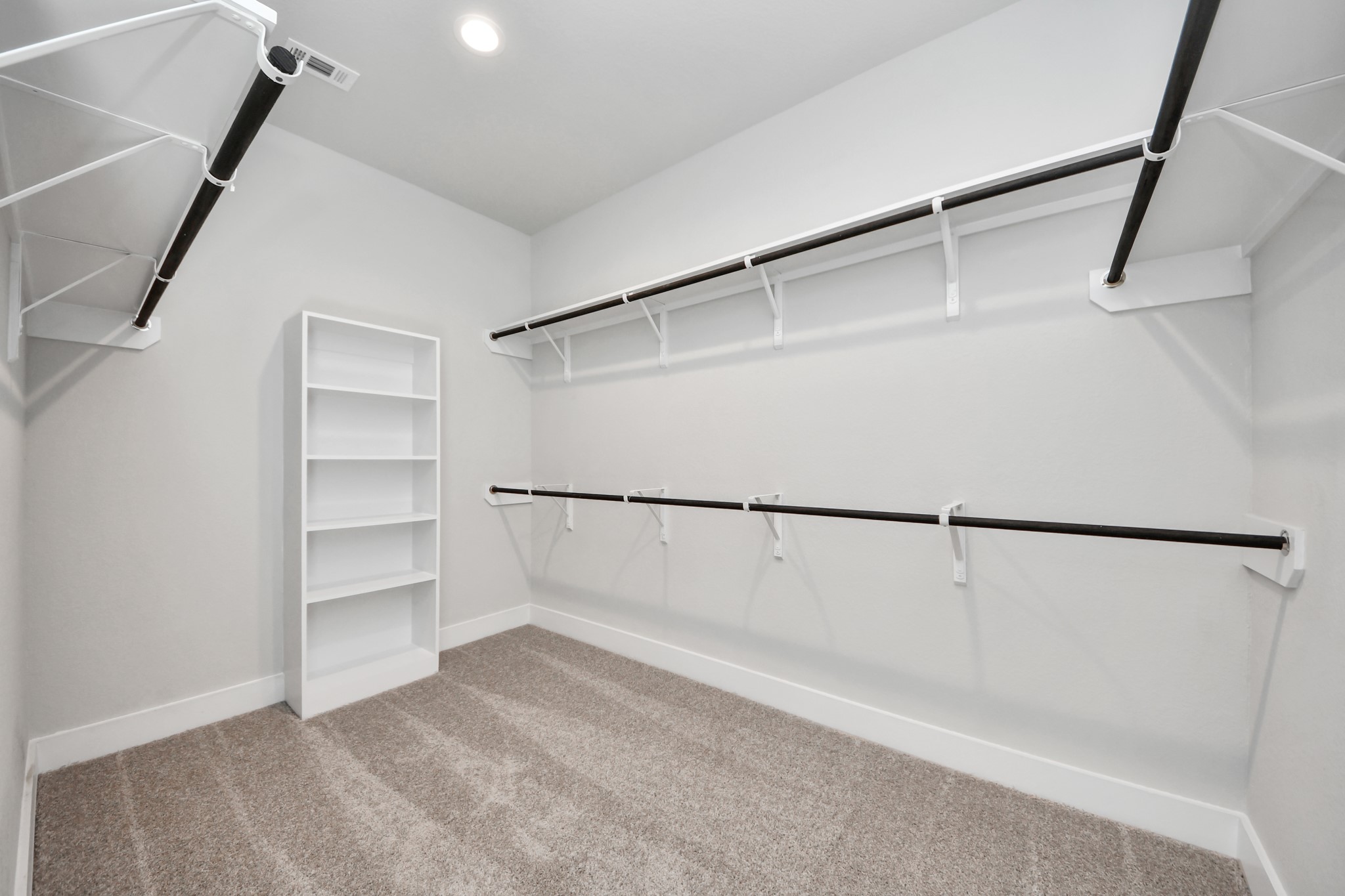 3102 Native Spg Drive Spring, TX 77373 - Photo 26 of 40 Walk-in closet that epitomizes luxury and practicality. This generously sized space features built-in shelving, offering abundant room for impeccable organization. High ceilings and recessed lighting create a bright and welcoming ambiance. Sample photo of completed home with similar floor plan. Actual colors and selections may vary.