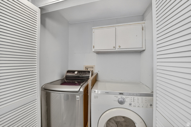 160 Cushing Way Layton, UT 84041 - Photo 13 of 23 Dedicated laundry area featuring louvered bi-fold doors and overhead cabinetry