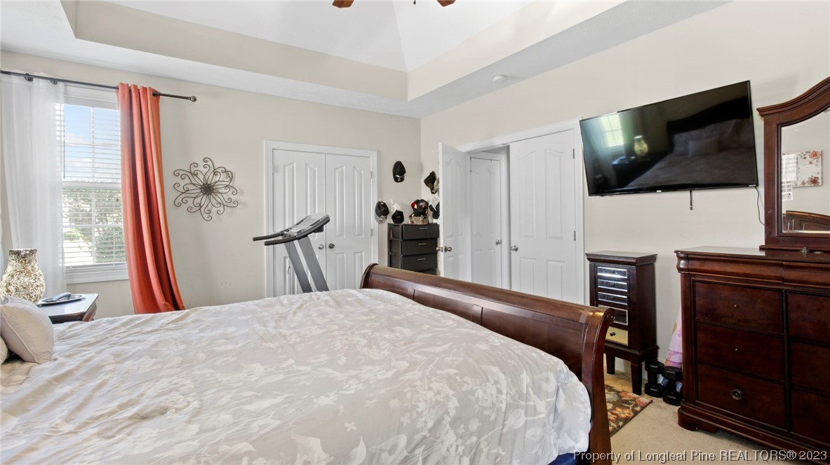 517 St Thomas Road Fayetteville, NC 28311 - Photo 12 of 47 a large bedroom with a bed and a flat screen tv