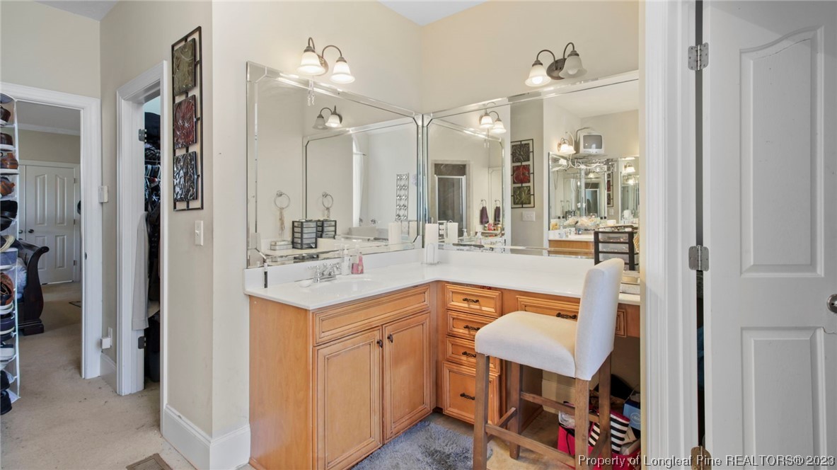517 St Thomas Road Fayetteville, NC 28311 - Photo 14 of 47 a bathroom with a sink a mirror a vanity and shower