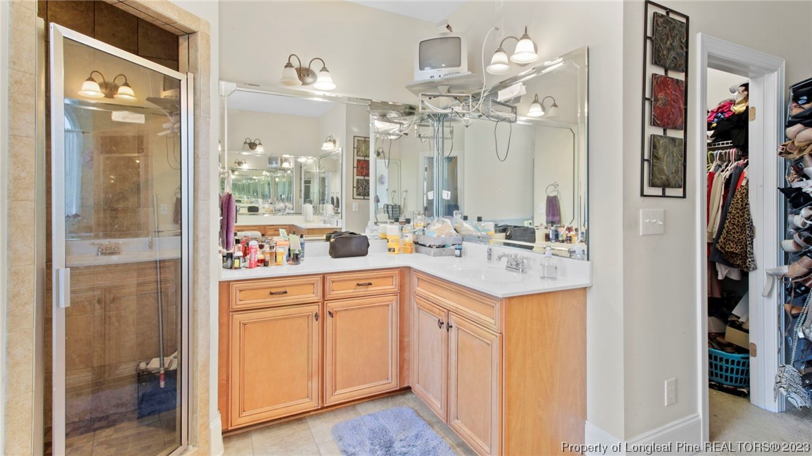 517 St Thomas Road Fayetteville, NC 28311 - Photo 15 of 47 a bathroom with a sink vanity and a mirror