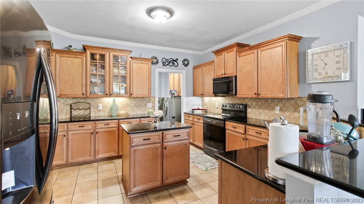 517 St Thomas Road Fayetteville, NC 28311 - Photo 21 of 47 a kitchen with stainless steel appliances granite countertop a refrigerator stove top oven and sink