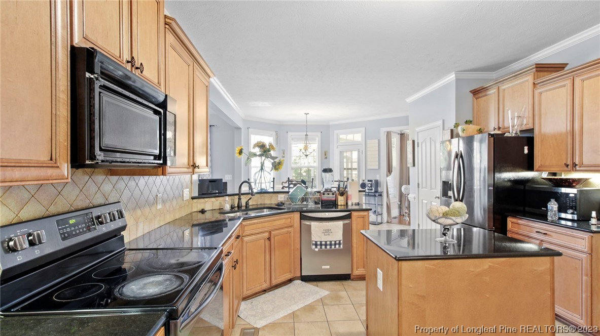 517 St Thomas Road Fayetteville, NC 28311 - Photo 22 of 47 a kitchen with stainless steel appliances granite countertop a sink stove and cabinets