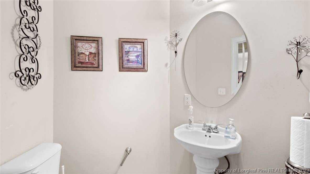 517 St Thomas Road Fayetteville, NC 28311 - Photo 24 of 47 a bathroom with a sink mirror and toilet