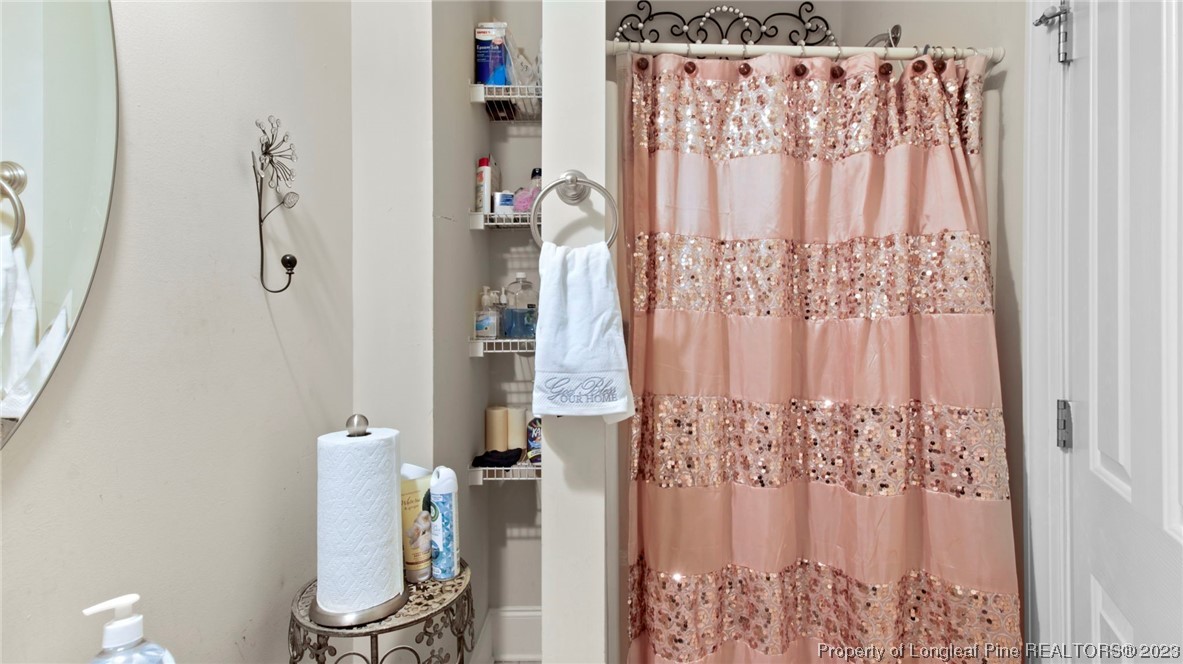517 St Thomas Road Fayetteville, NC 28311 - Photo 25 of 47 a white toilet sitting next to a shower curtain