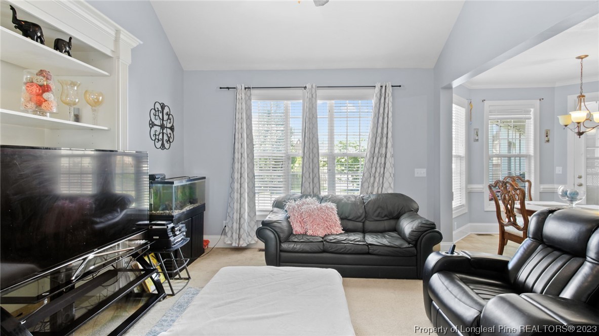517 St Thomas Road Fayetteville, NC 28311 - Photo 29 of 47 a living room with furniture and a flat screen tv