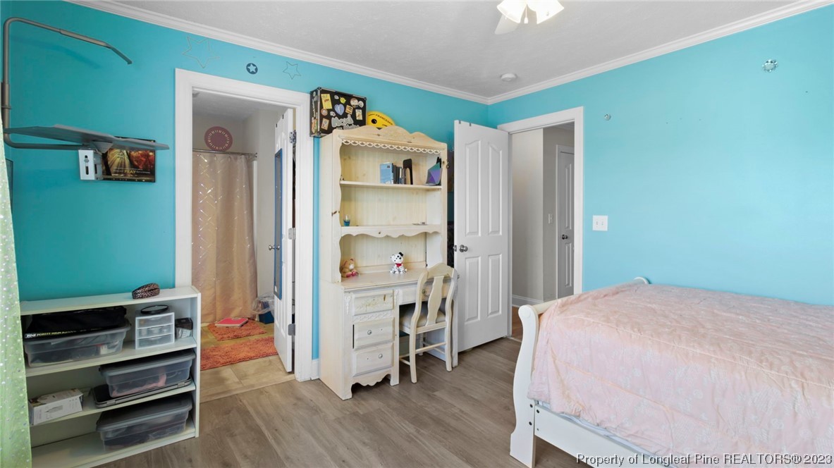 517 St Thomas Road Fayetteville, NC 28311 - Photo 33 of 47 a bedroom with a bed and a chandelier