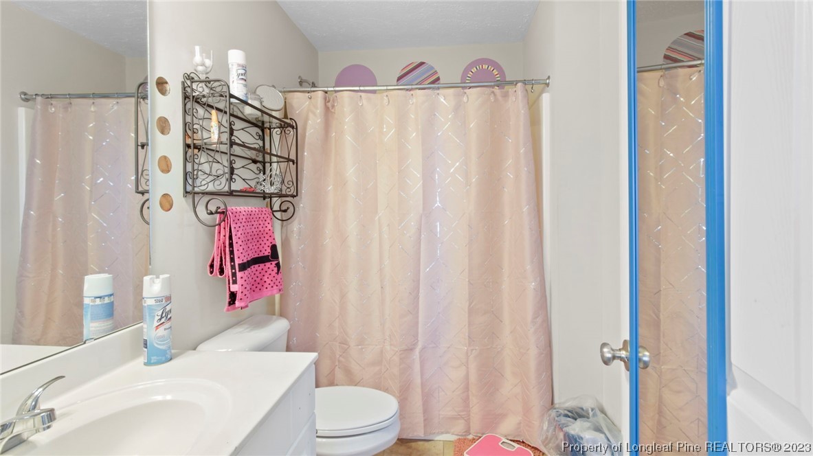 517 St Thomas Road Fayetteville, NC 28311 - Photo 34 of 47 a bathroom with a toilet sink and shower curtain