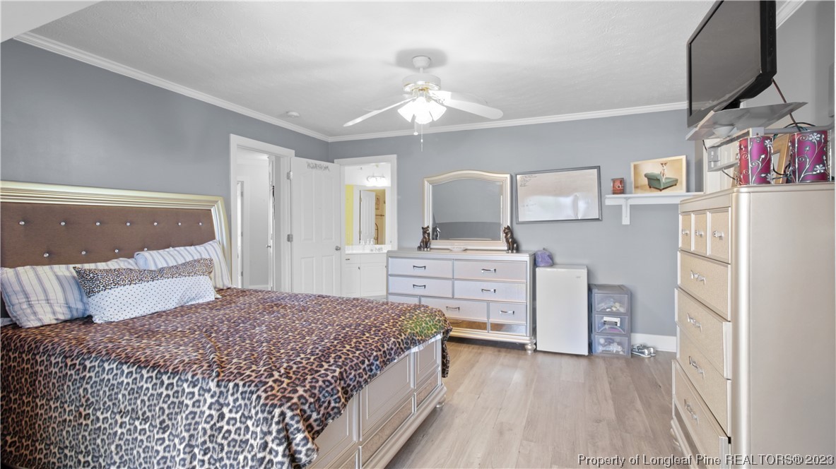 517 St Thomas Road Fayetteville, NC 28311 - Photo 36 of 47 a bedroom with a bed and a flat screen tv