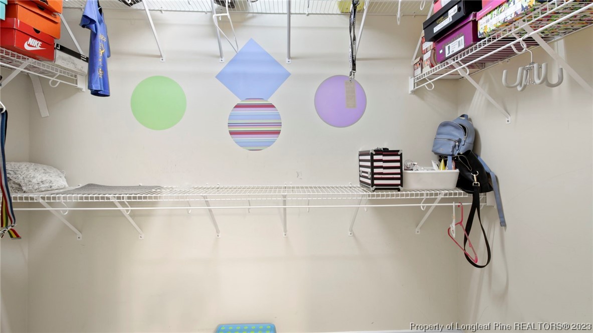 517 St Thomas Road Fayetteville, NC 28311 - Photo 39 of 47 a view of a room with shelves and wooden floors