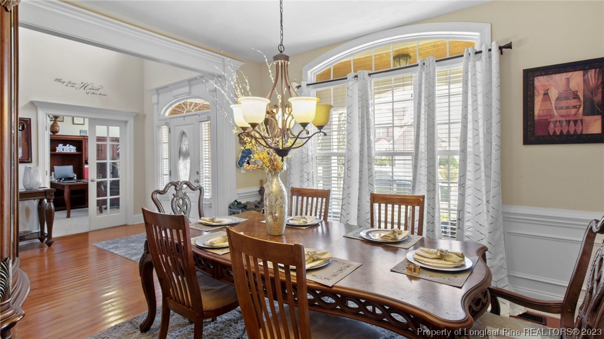 517 St Thomas Road Fayetteville, NC 28311 - Photo 9 of 47 a dining room with furniture a chandelier and wooden floor