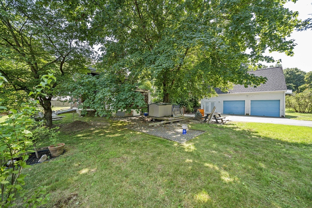 246 Dedham Street Canton, MA 02021 - Photo 5 of 9 a backyard of a house with table and chairs plants and large tree