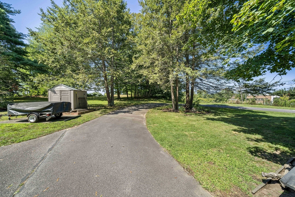 246 Dedham Street Canton, MA 02021 - Photo 7 of 9 a view of a street with a big yard and large trees