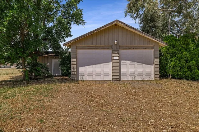 a front view of house with yard and trees