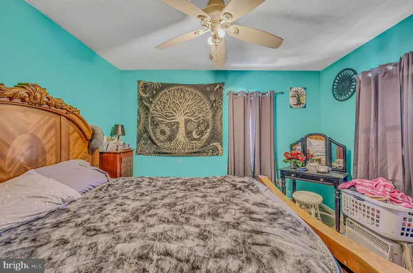 a bedroom with a bed dresser and a baby crib