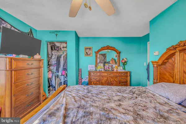 a bedroom with bed and dresser