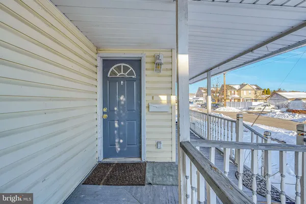 a view of a porch with wooden floor
