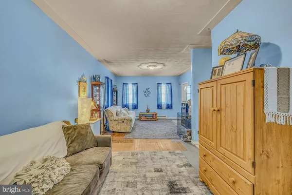 a living room with furniture and a painting on the wall
